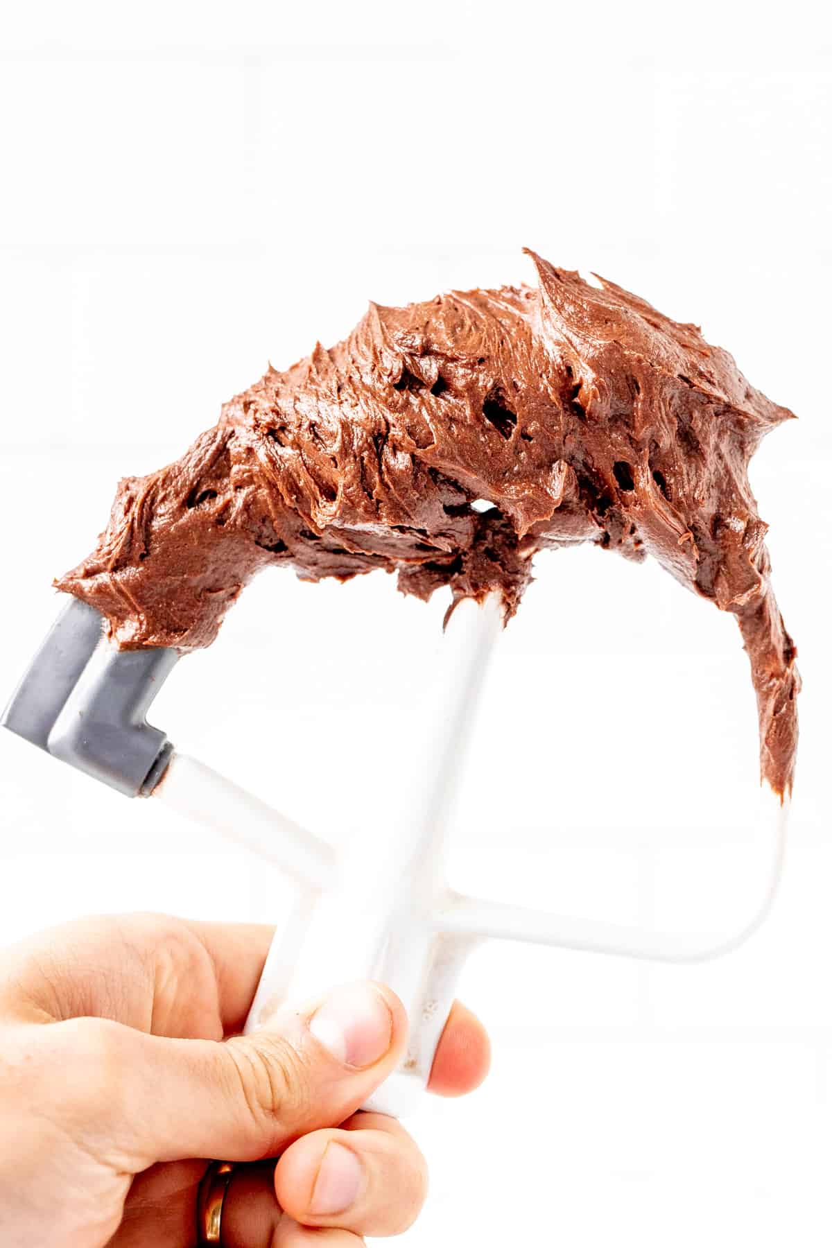 Kitchenaid beater covered in chocolate frosting