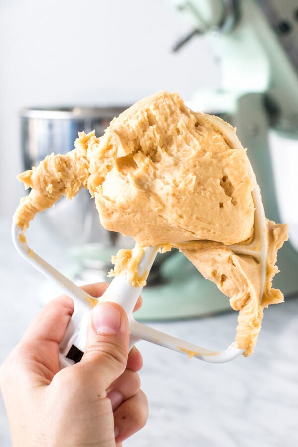 Paddle attachment of mixer with caramel frosting. 