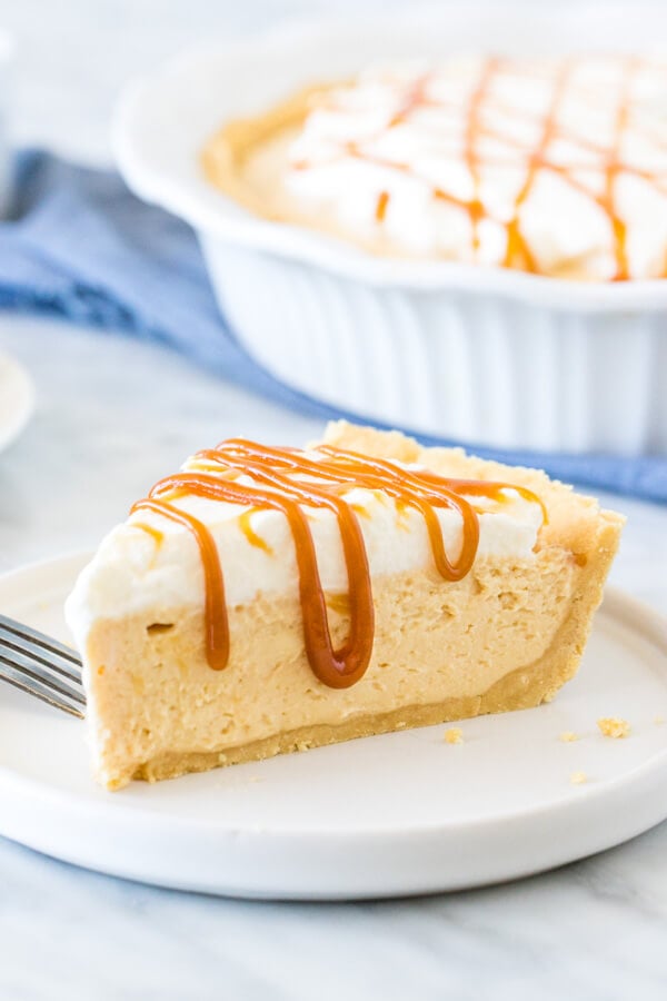 Slice of caramel pie with whipped cream on top. 