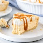 Slice of no-bake caramel cream pie with a bite taken out of it.