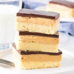 Stack of 3 peanut butter shortbread bars with a glass of milk.