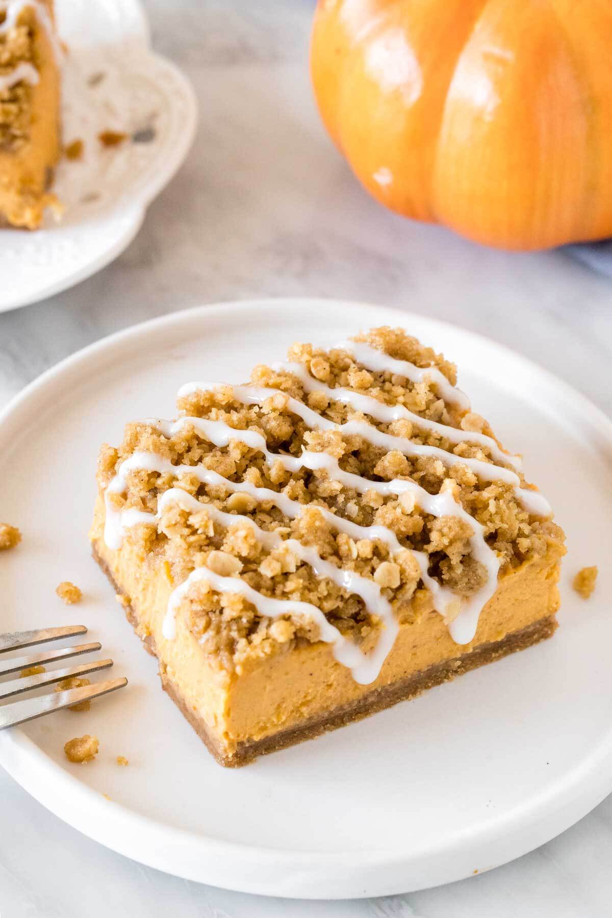 Pumpkin bar with oatmeal topping and a drizzle of vanilla glaze. 