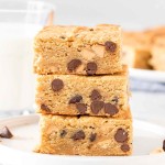 Stack of 3 peanut butter cookie bars with chocolate chips.