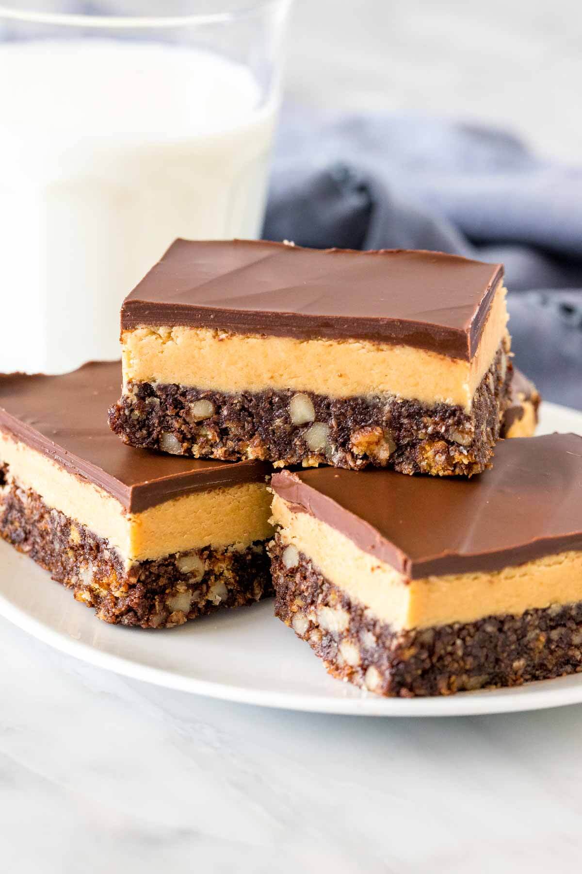 Plate of peanut butter nanaimo bars with a glass of milk