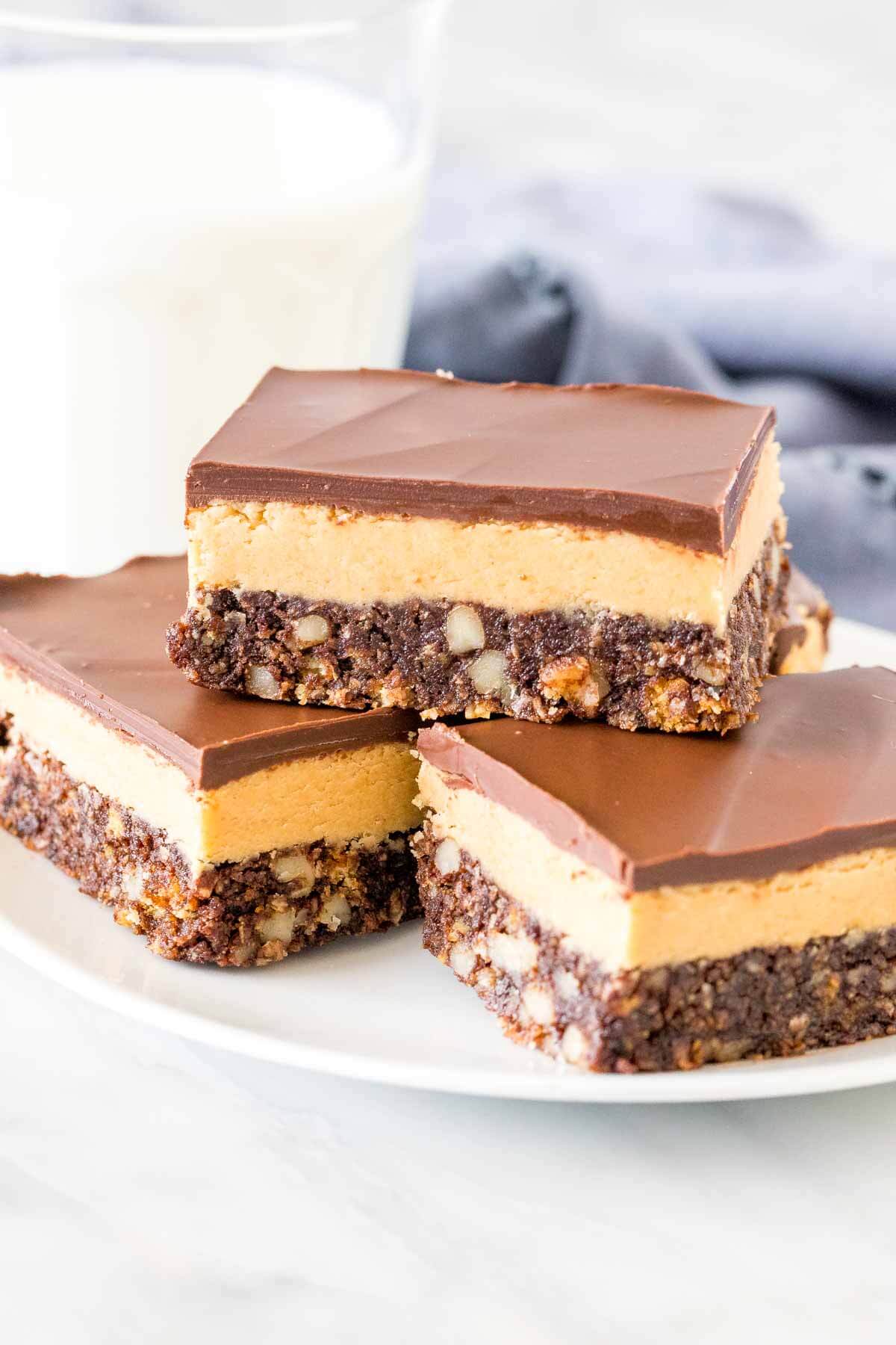 Plate of nanaimo bars with peanut butte rfilling. 