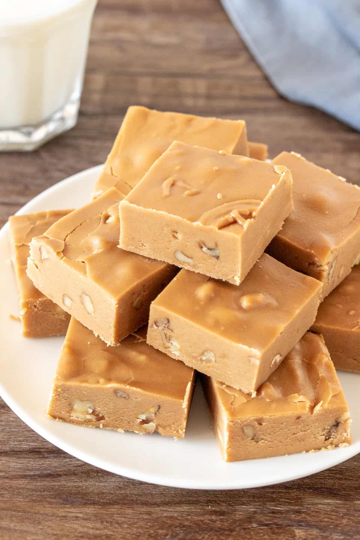 Plate of brown sugar fudge with a glass of milk.