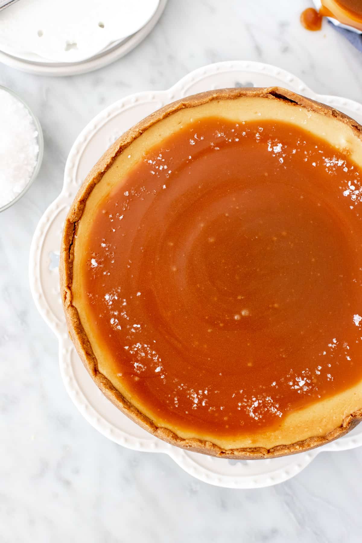 9-inch round cheesecake with caramel sauce on top.