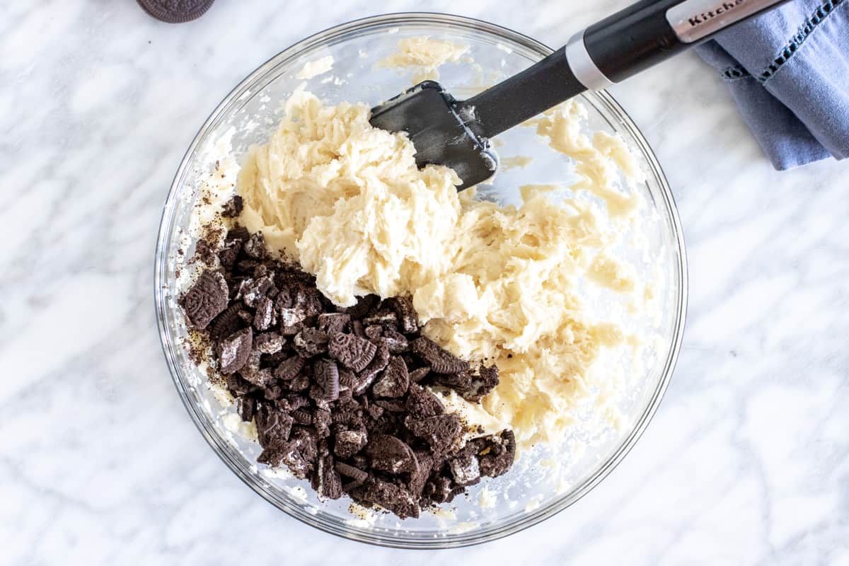 Bowl of cookie dough with chopped Oreo cookies. 
