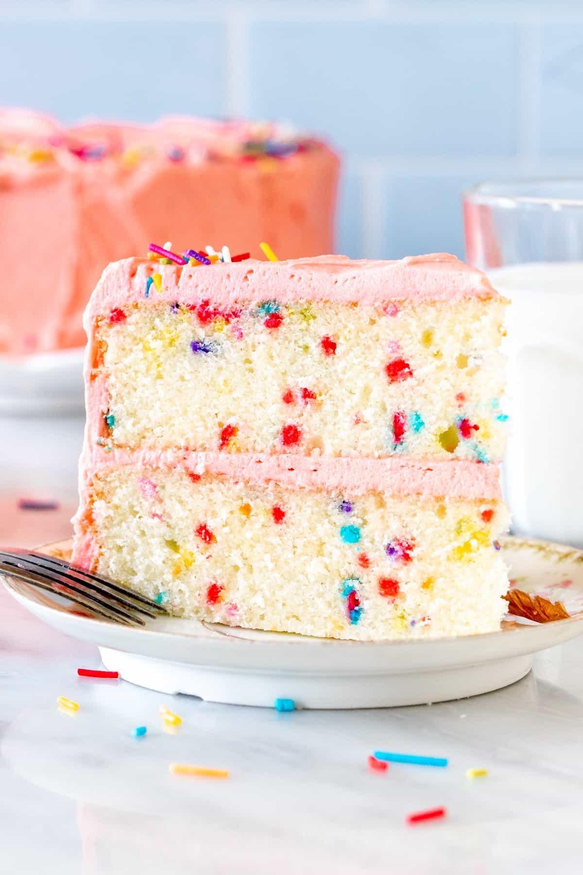 Slice of funfetti cake with pink frosting