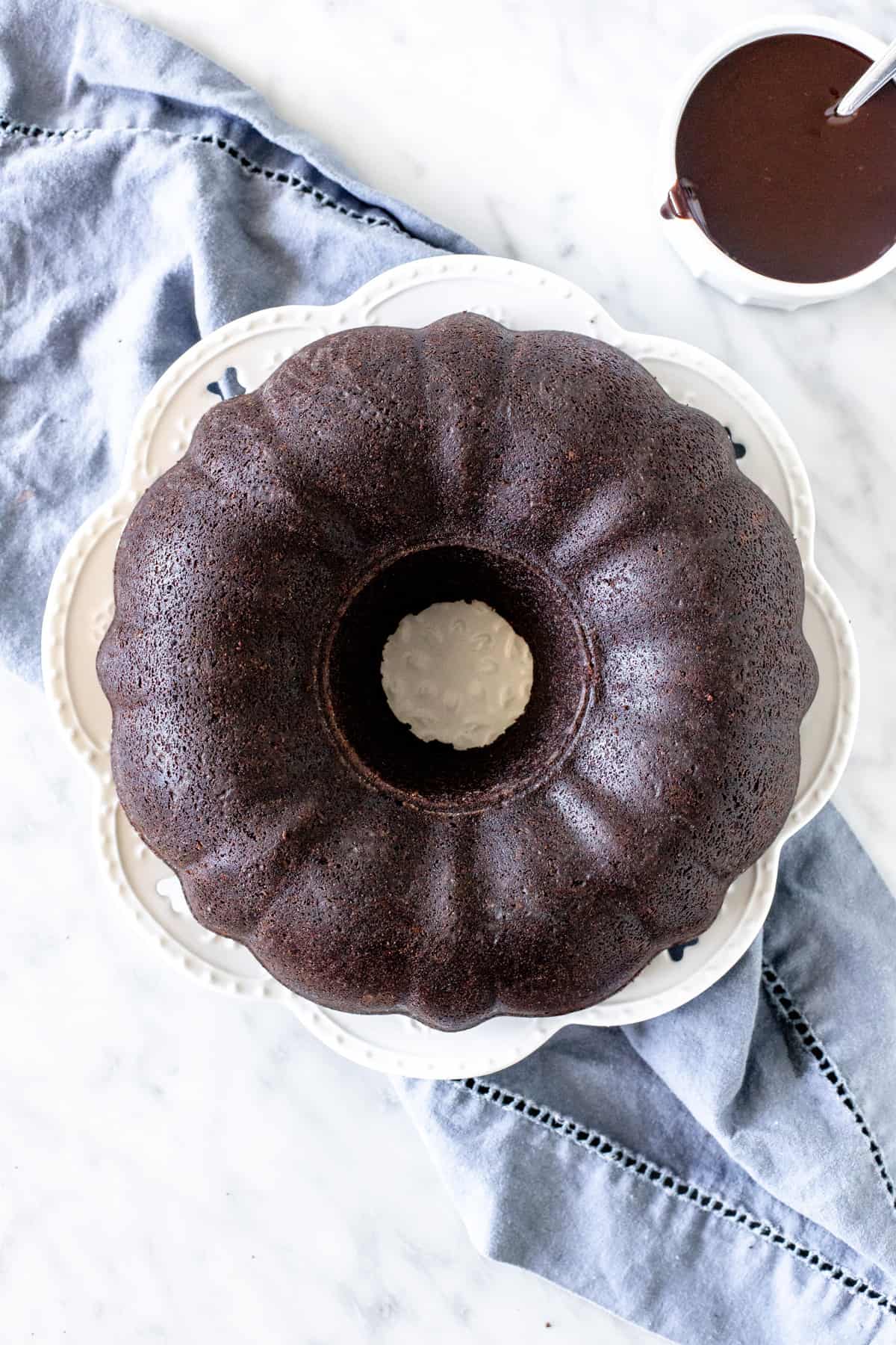 Chocolate cake made in a bundt pan on a plate.