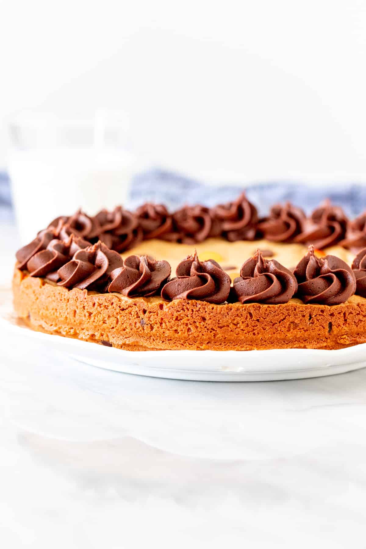 Peanut butter cookie cake with chocolate frosting around the edges