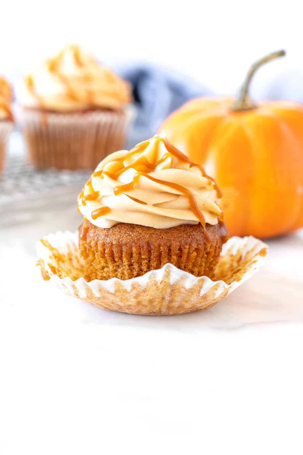 Pumpkin cupcake with caramel buttercream and a decorative pumpkin