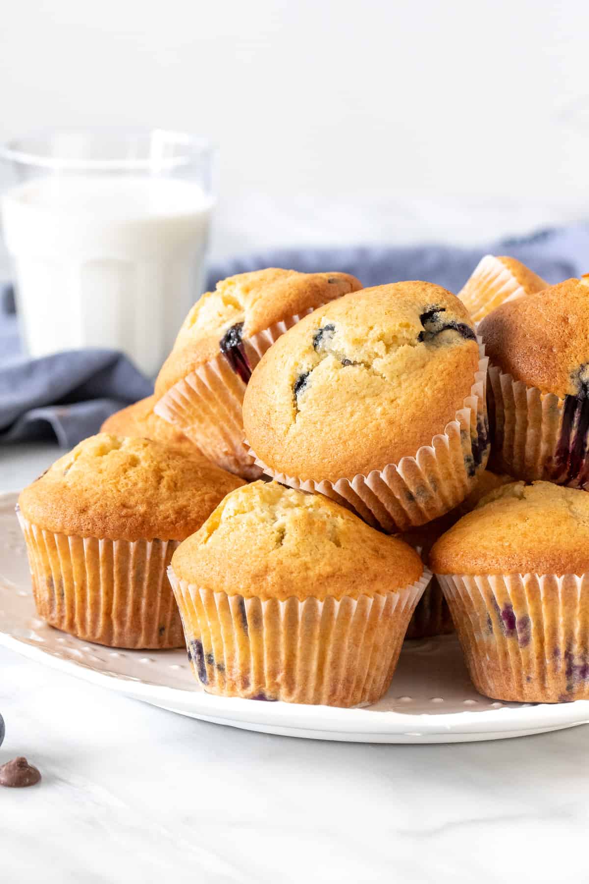 Plate of muffins, stacked on top of each other.