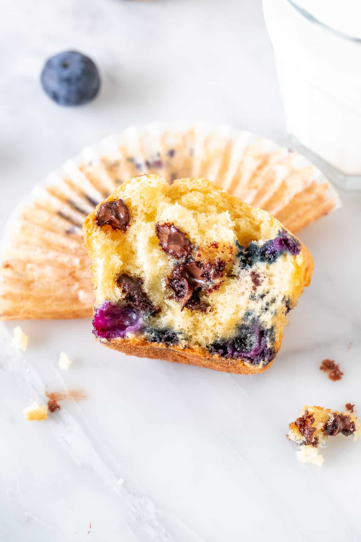 Half of a blueberry chocolate chip muffin.