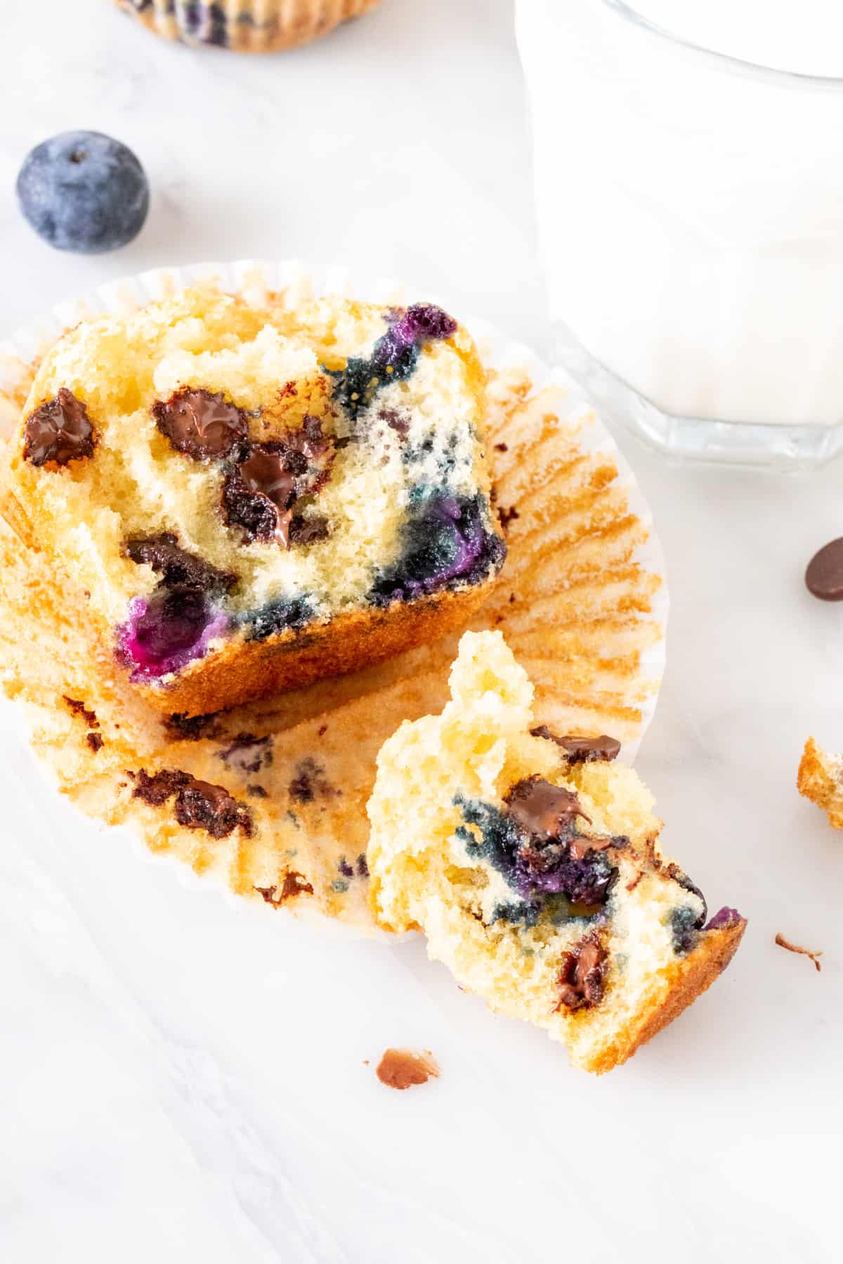 Broken muffin filled with blueberries and chocolate chips