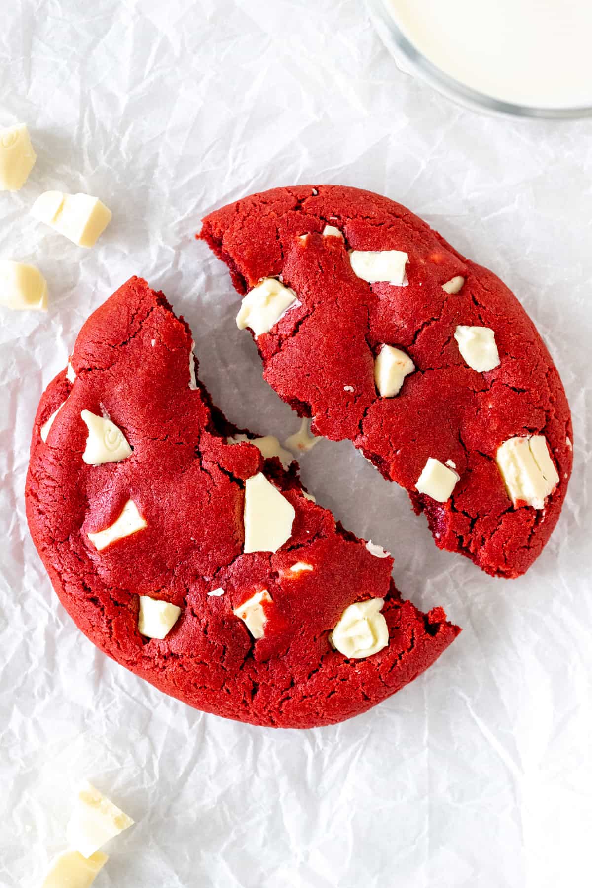 A red velvet cookie for one, broken in half.