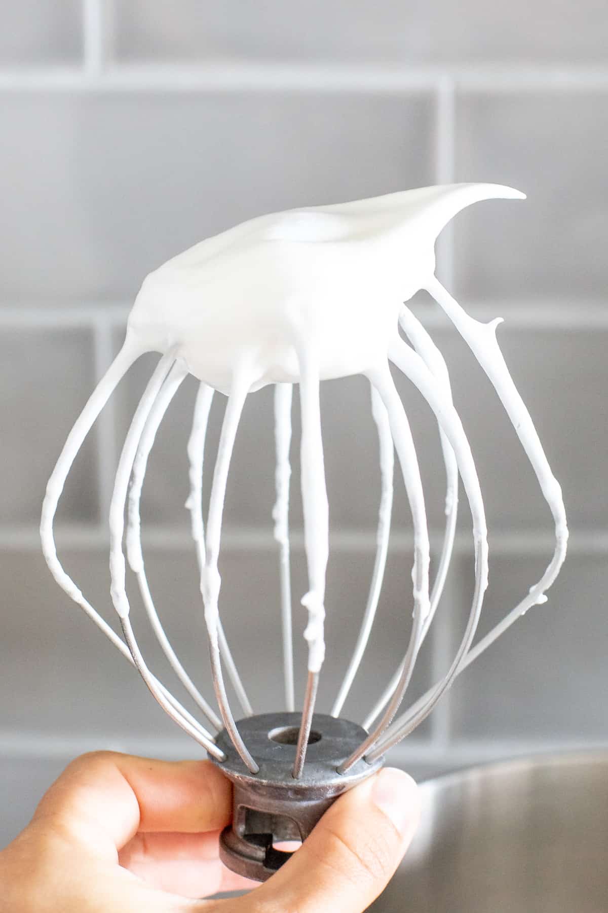 Whisk attachment of electric mixer with whipped egg whites