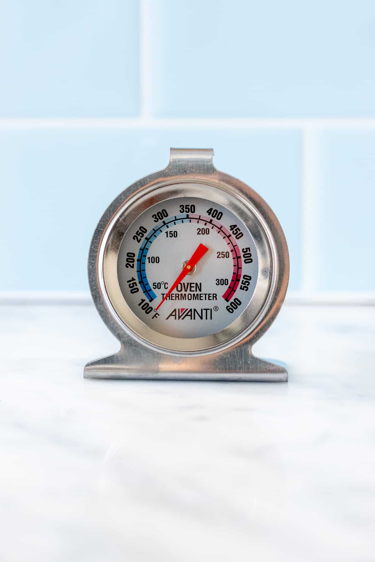 An oven thermometer on a kitchen counter