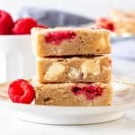 White chocolate raspberry blondies, stacked one on top of each other