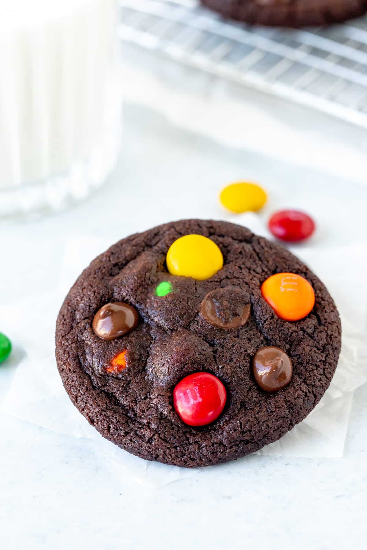 M&M chocolate cookie with glass of milk