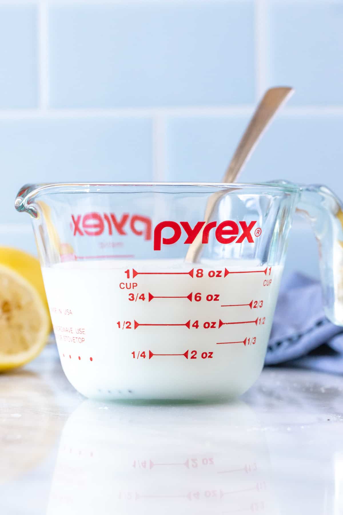 Measuring cup of homemade buttermilk