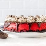 9-inch round red velvet cheesecake with Oreo crust and topped with chocolate ganache, whipped cream and crushed Oreos
