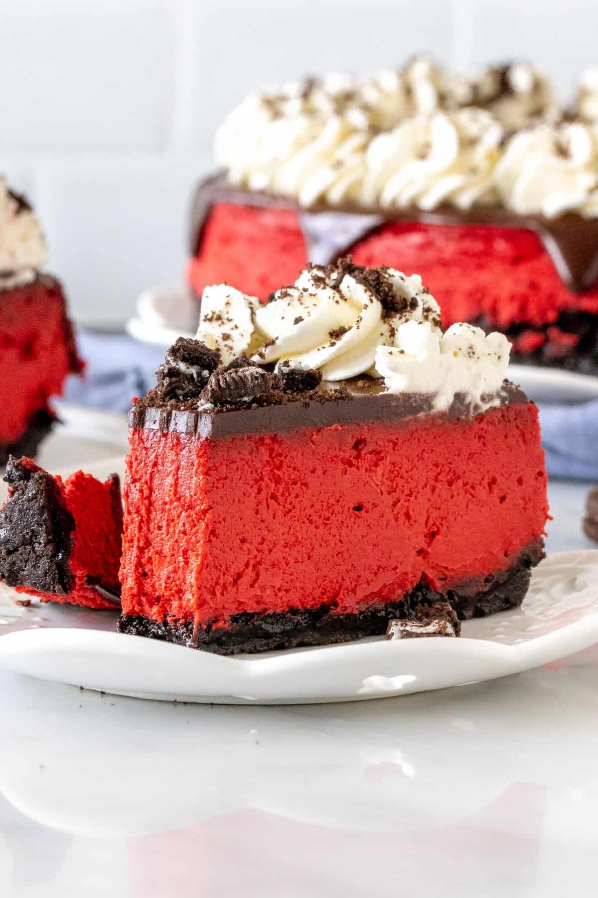 Slice of red velvet Oreo cheesecake with a bite taken out