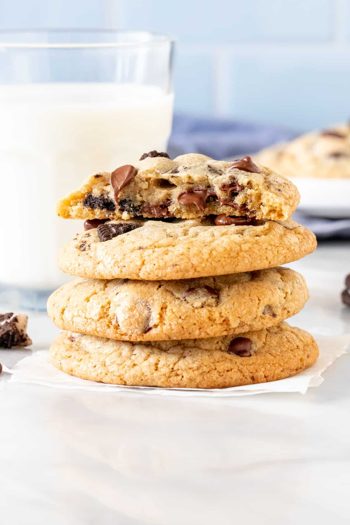 Stack of chocolate chip cookies made with Oreo chunks.