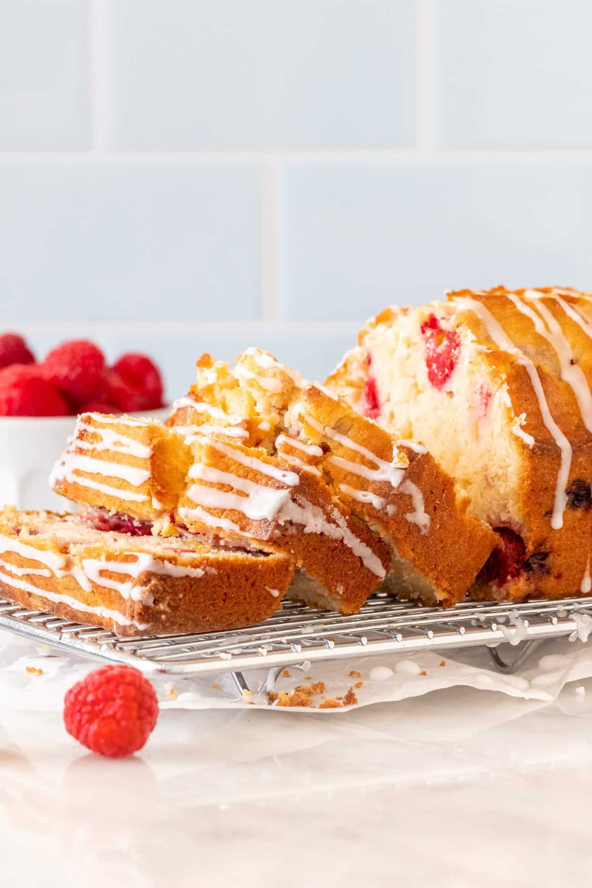 Raspberry bread with 3 slices cut on a cooling rack