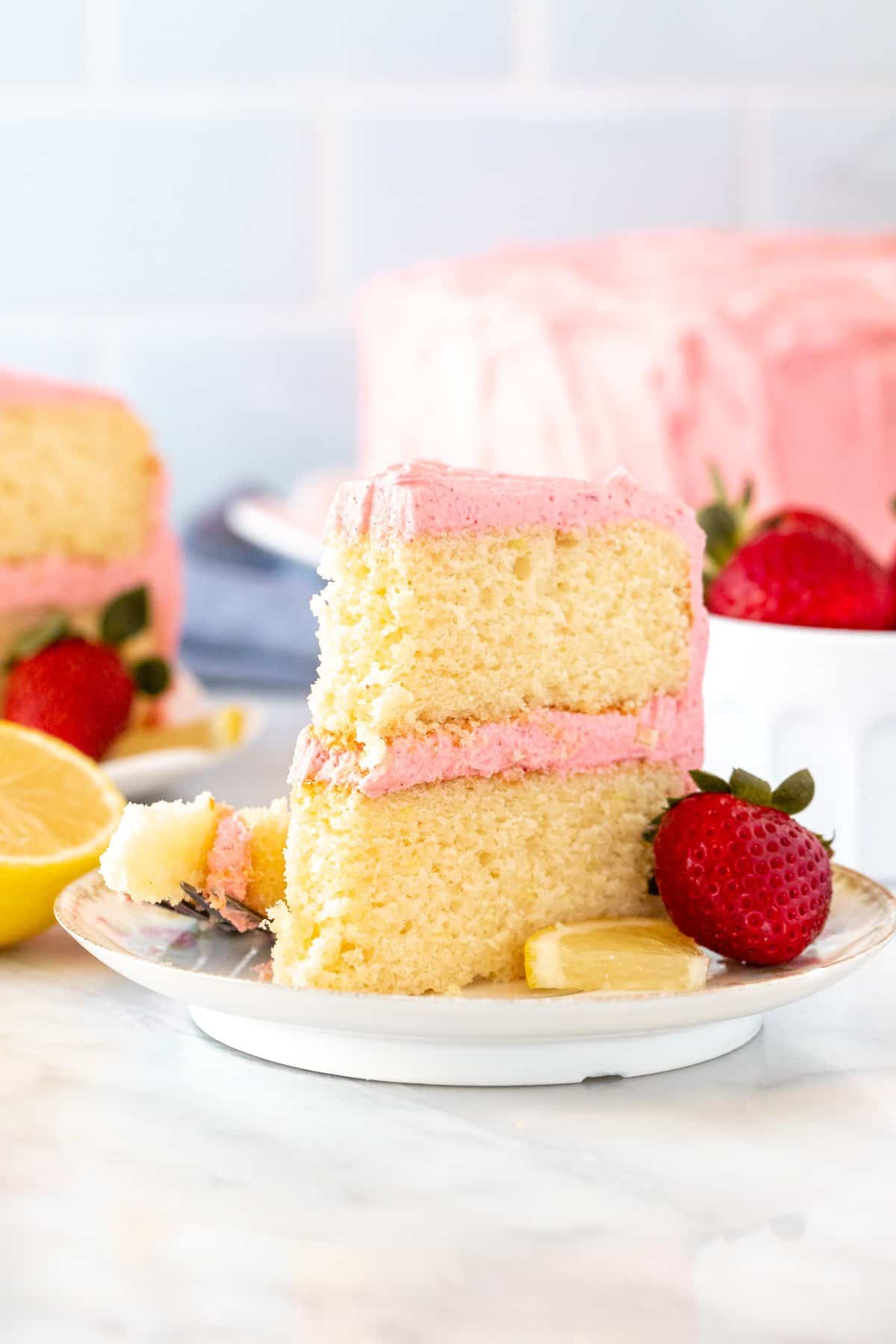 Slice of lemon layer cake with strawberry frosting