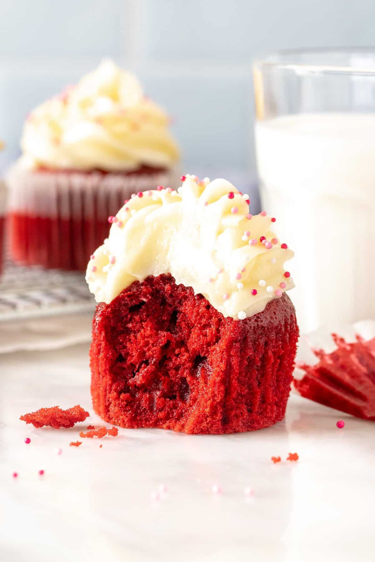 Red velvet cupcake with cream cheese frosting with bite taken out