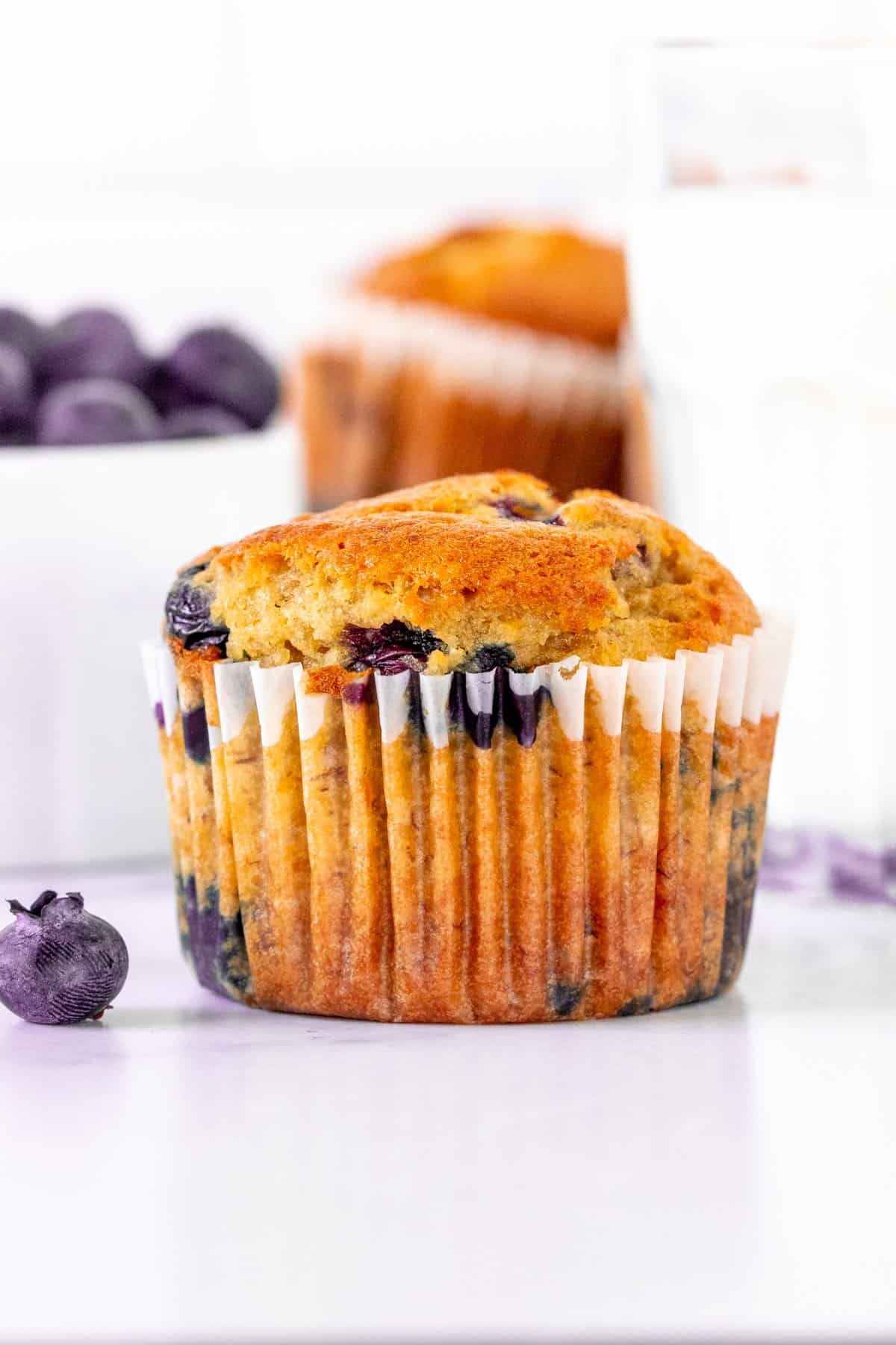 Blueberry banana muffin with glass of milk.