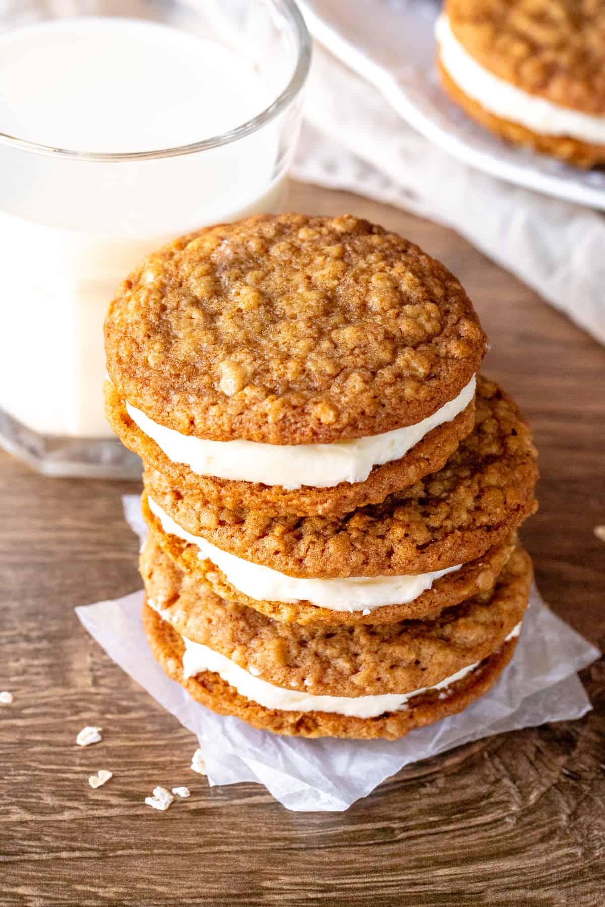 Stack of three oatmeal cream pies with glass of milk