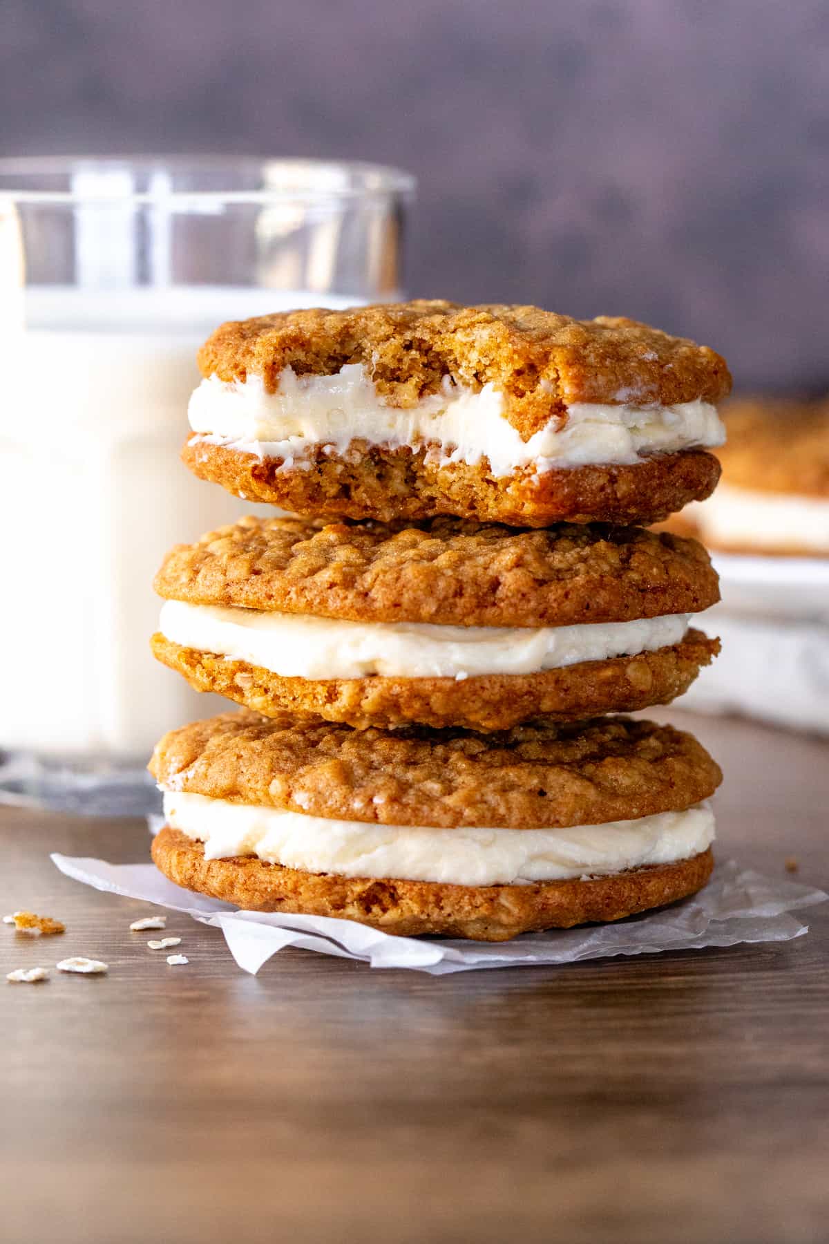 Three oatmeal cream pie cookies with a bite out of the top cookie