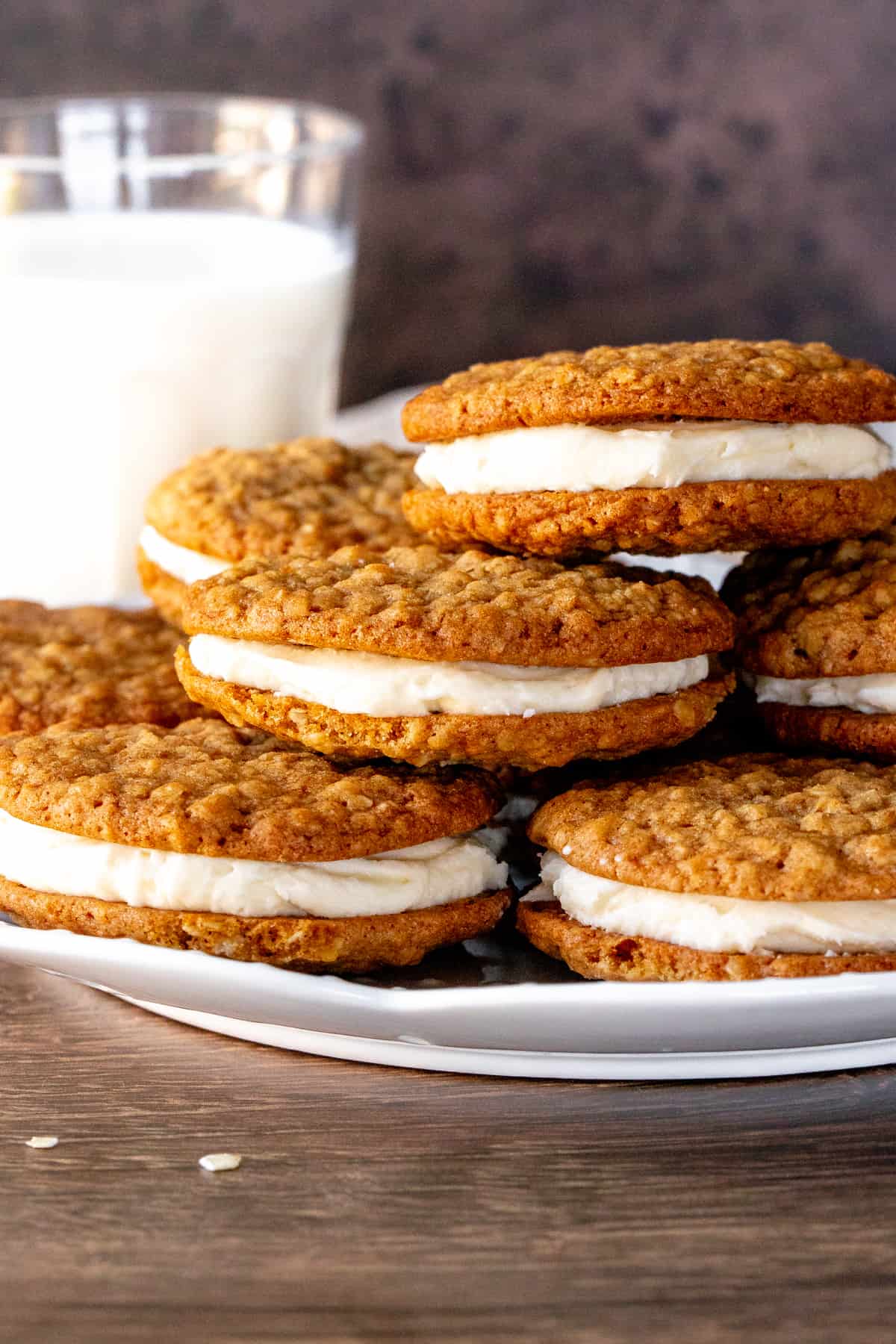 Plate of oatmeal sandwich cookies with vanilla frosting