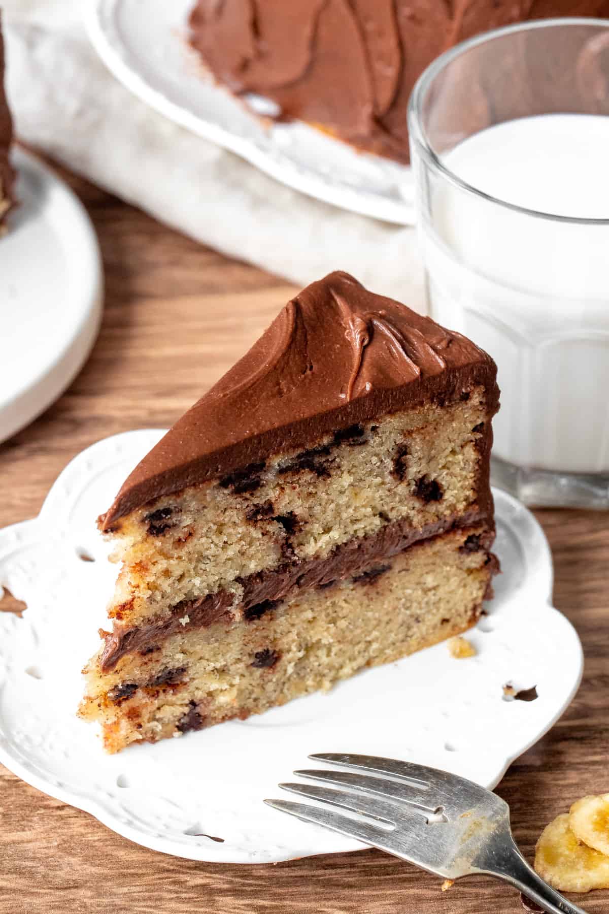 Slice of banana chocolate chip cake with chocolate frosting