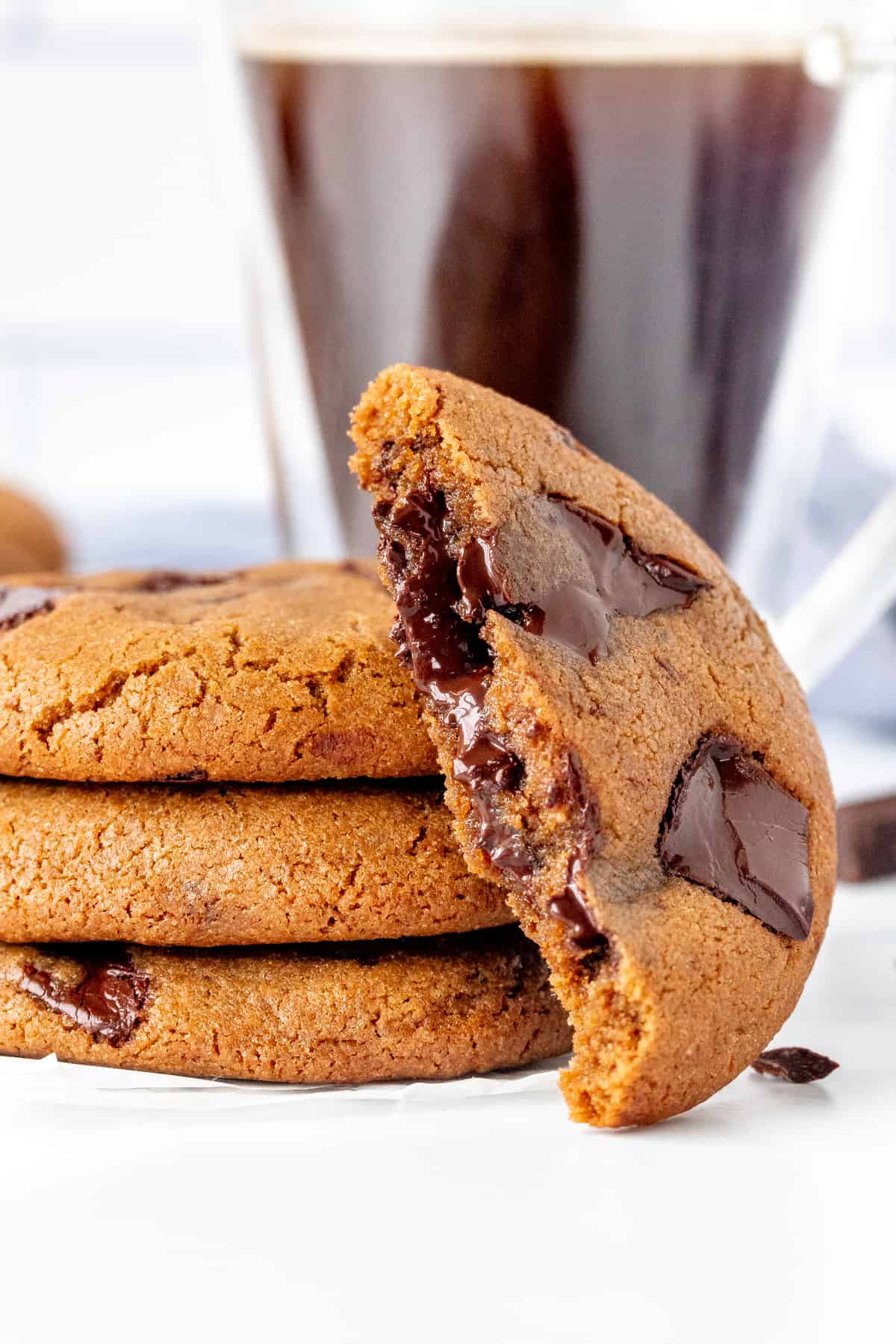 Stack of 3 espresso chocolate chunk cookies w/ half a cookie on its side