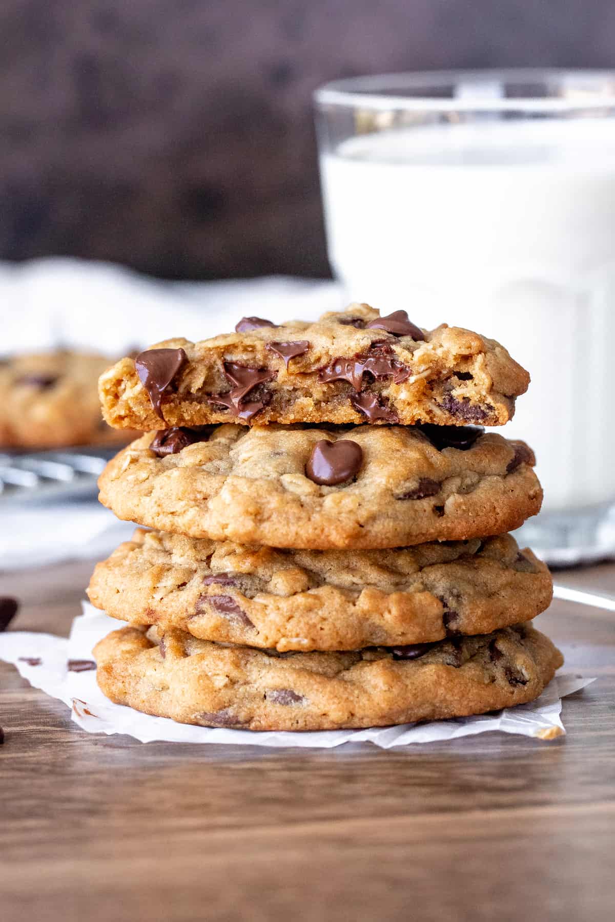 Stack of peanut butter oatmeal chocolate chip cookies with top cookie broken in half