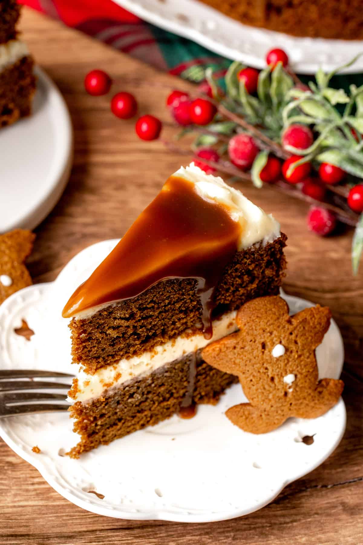 Slice of gingerbread cake with cream cheese frosting and butterscotch sauce