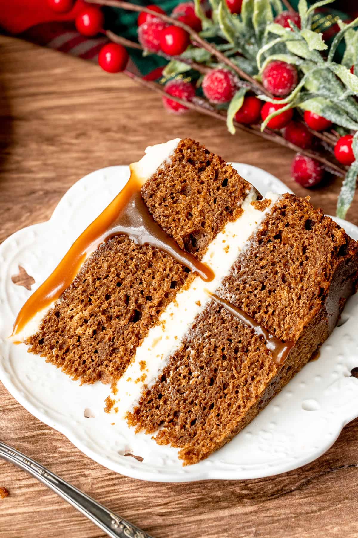 Slice of 2 layer gingerbread Christmas cake with cream cheese frosting and butterscotch topping