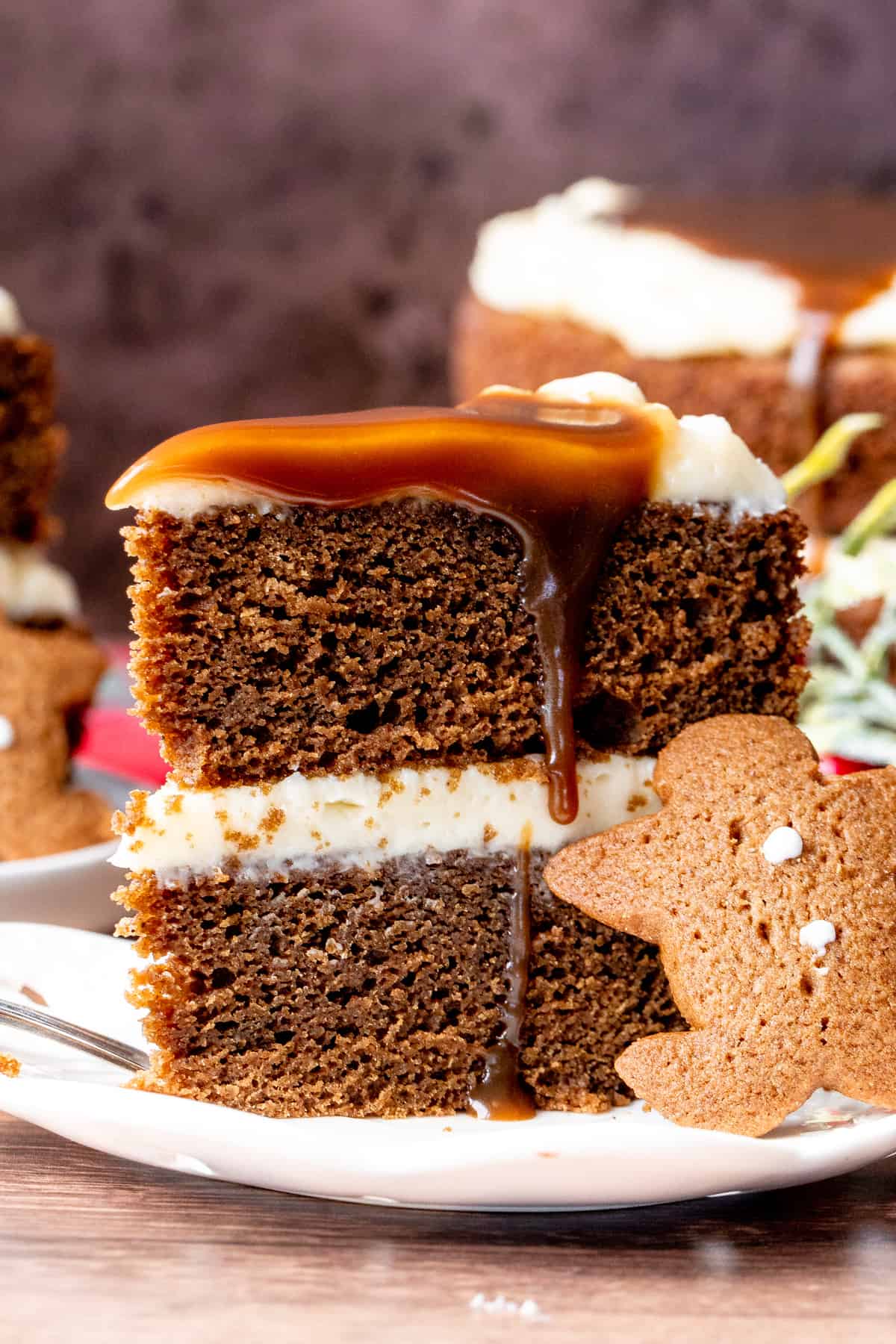 Slice of 2 layer gingerbread cake with cream cheese frosting