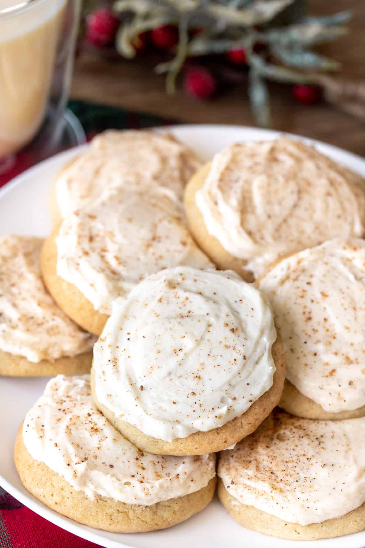 Plate of eggnog cookies frosted with eggnog buttercream and sprinkled with nutmeg