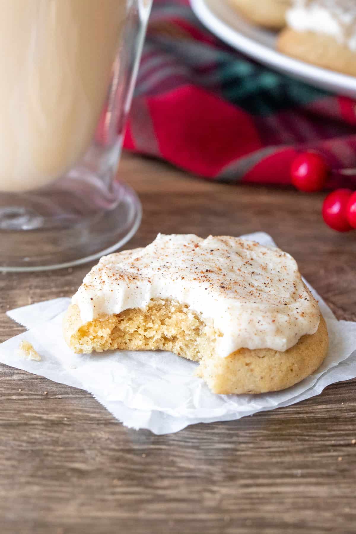 Eggnog cookie with eggnog buttercream with a bite taken out
