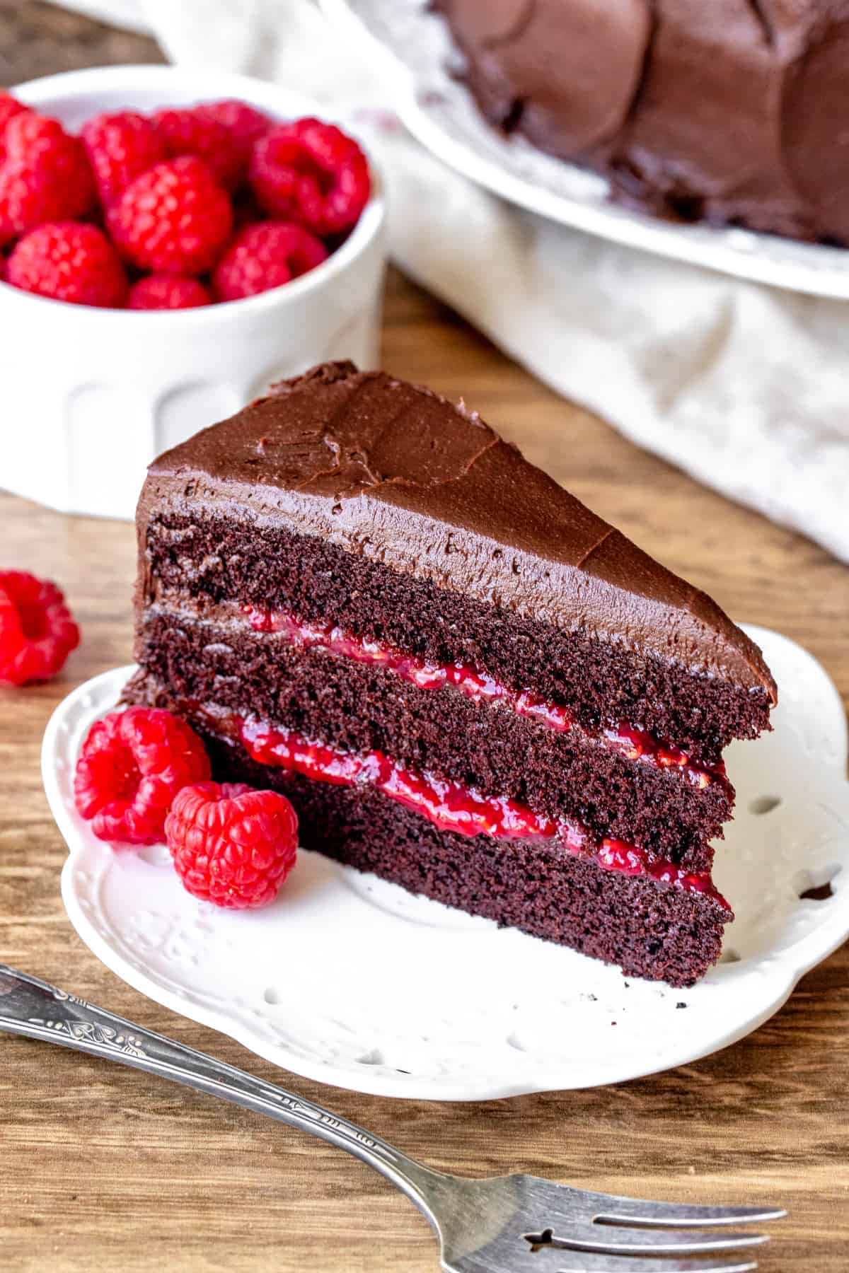 Piece of chocolate layer cake with raspberry filling