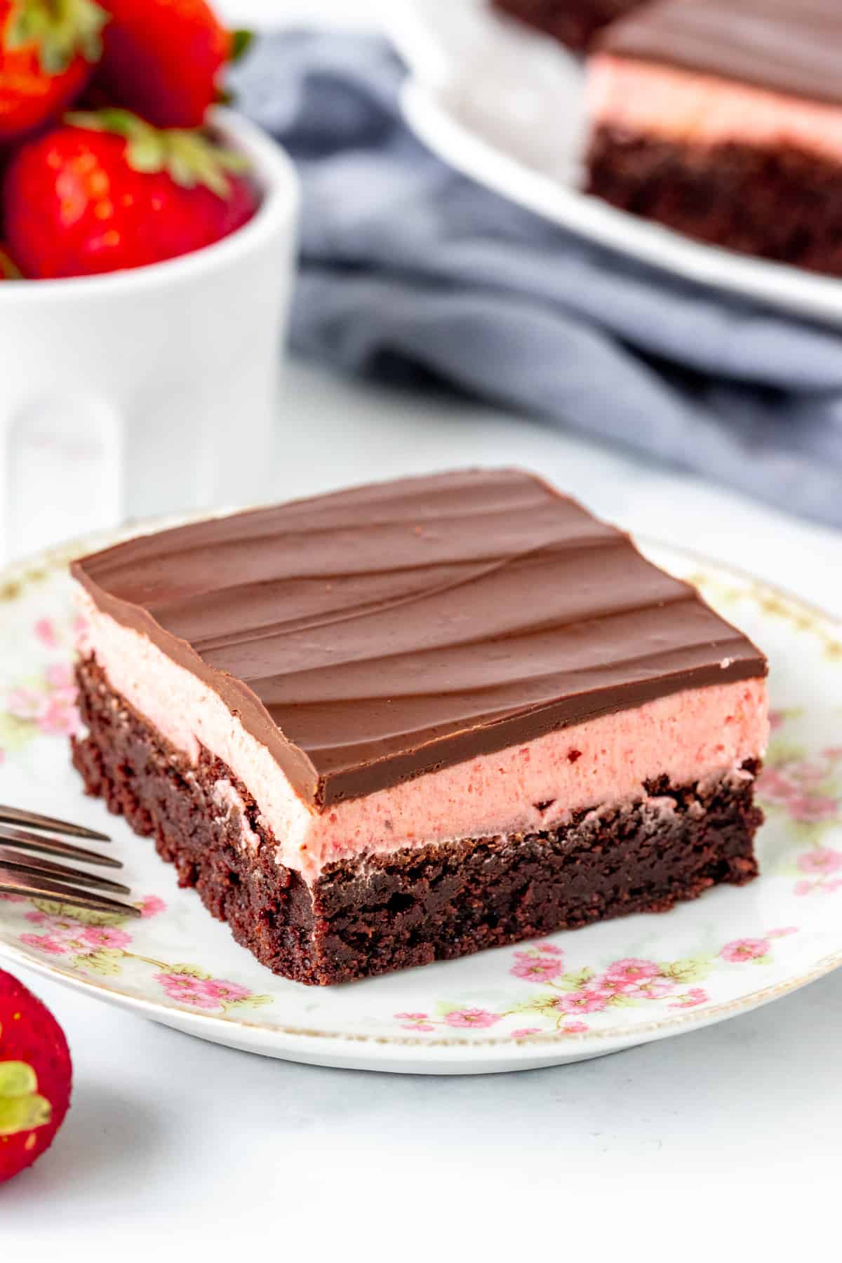 Strawberry brownie with a layer of strawberry frosting and chocolate on top