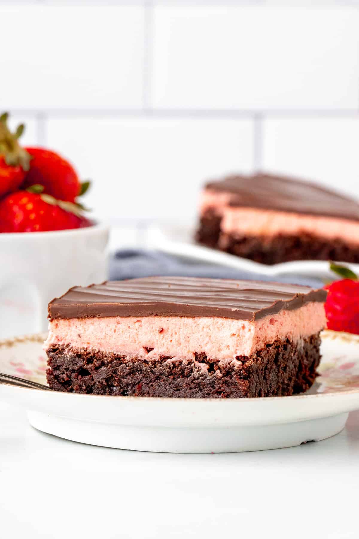 Brownie with a layer of strawberry frosting and chocolate topping