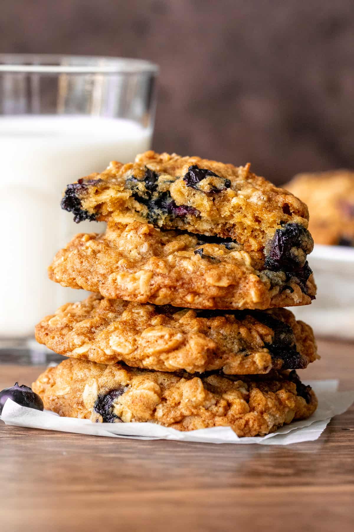 Stack of blueberry oatmeal cookies, with top cookie broken in half.