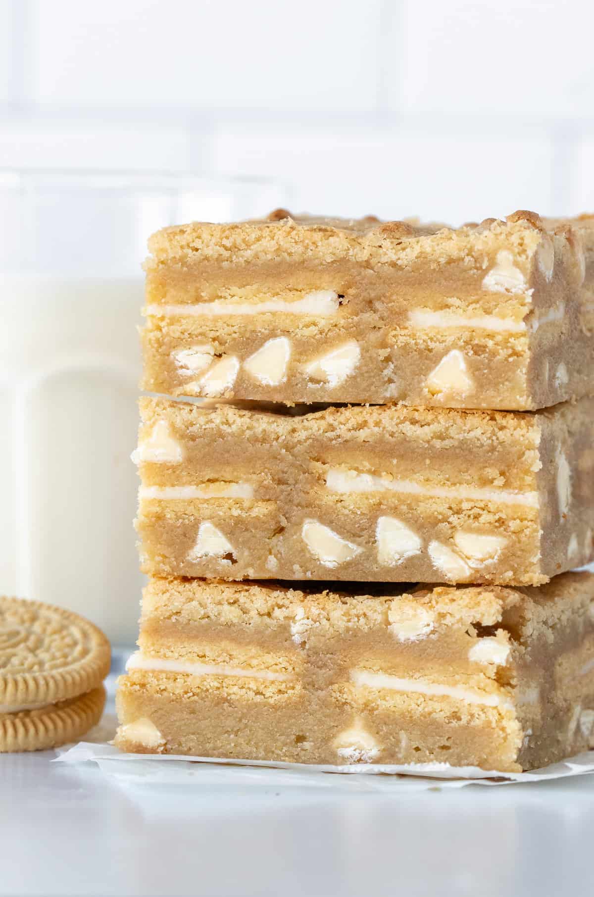 Three blondies stuffed with Golden Oreos, one on top of the other