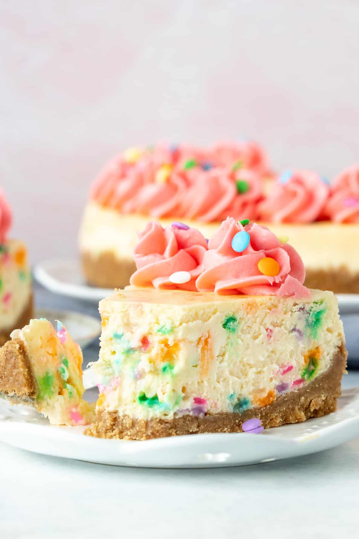 Piece of funfetti cheesecake with bite taken out