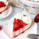 Slice of strawberry cheesecake pie with whipped cream on top